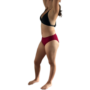 transgender woman wearing a compressive bikini bottom that is magenta